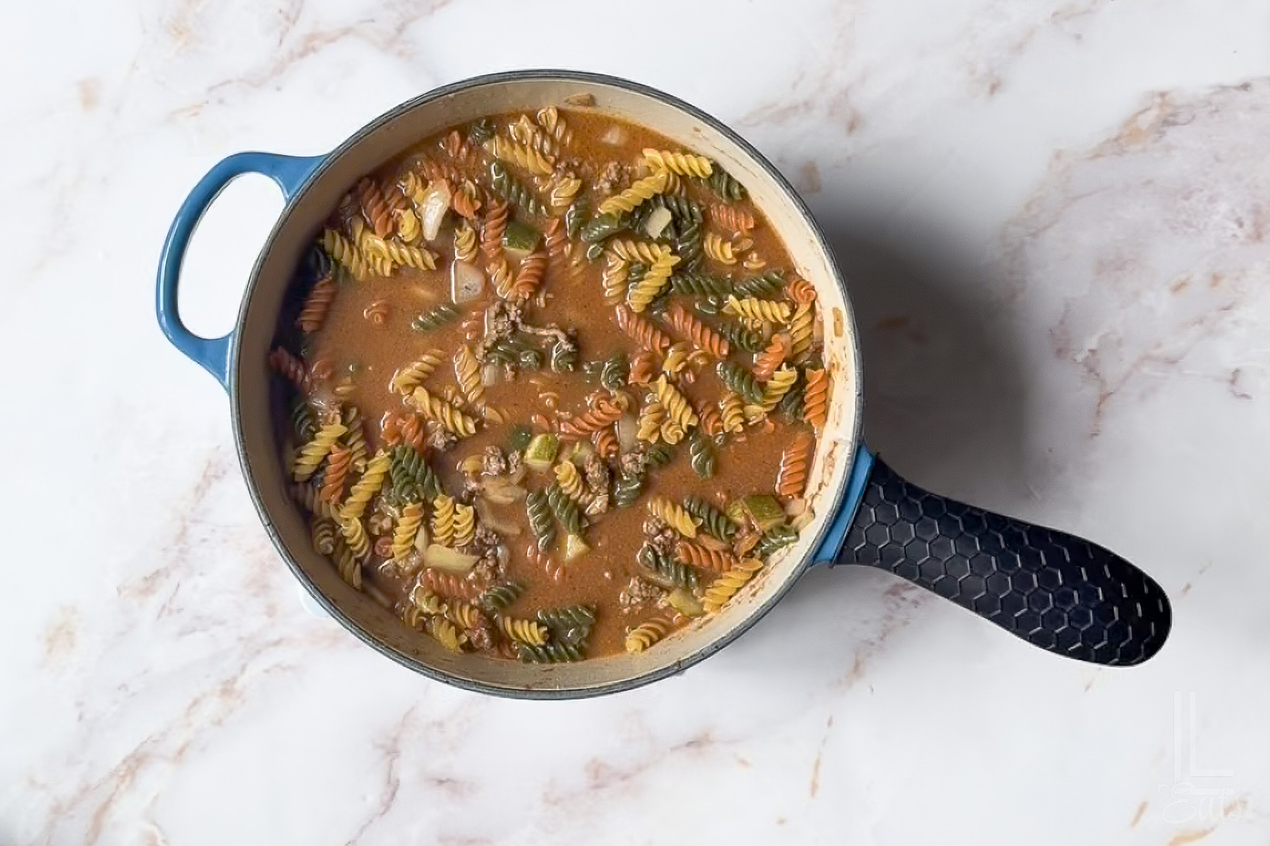 chicken broth and rotini pasta added to the burger sauce mixture.