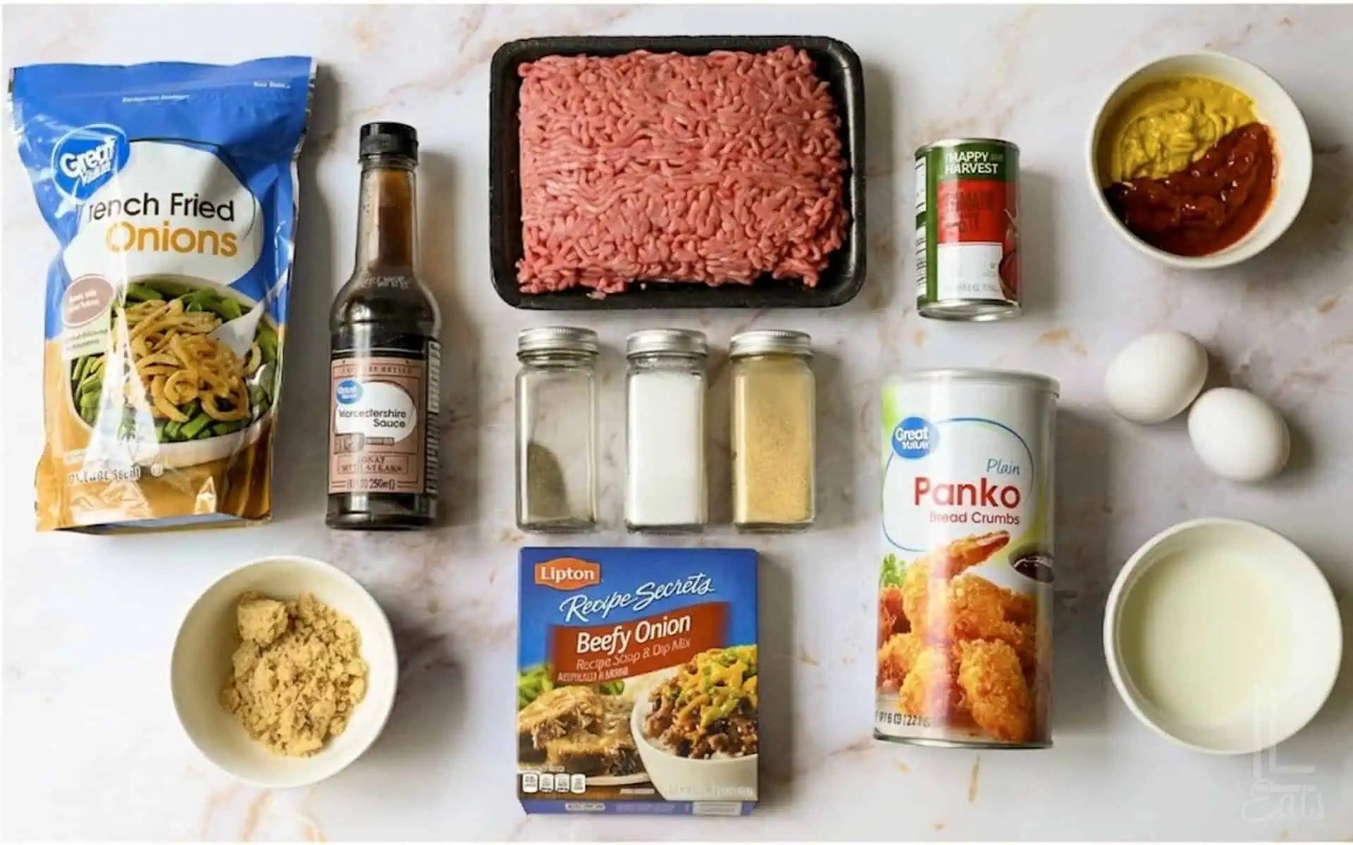 Ingredients for Lipton onion soup meatloaf with onions, eggs, and spices.