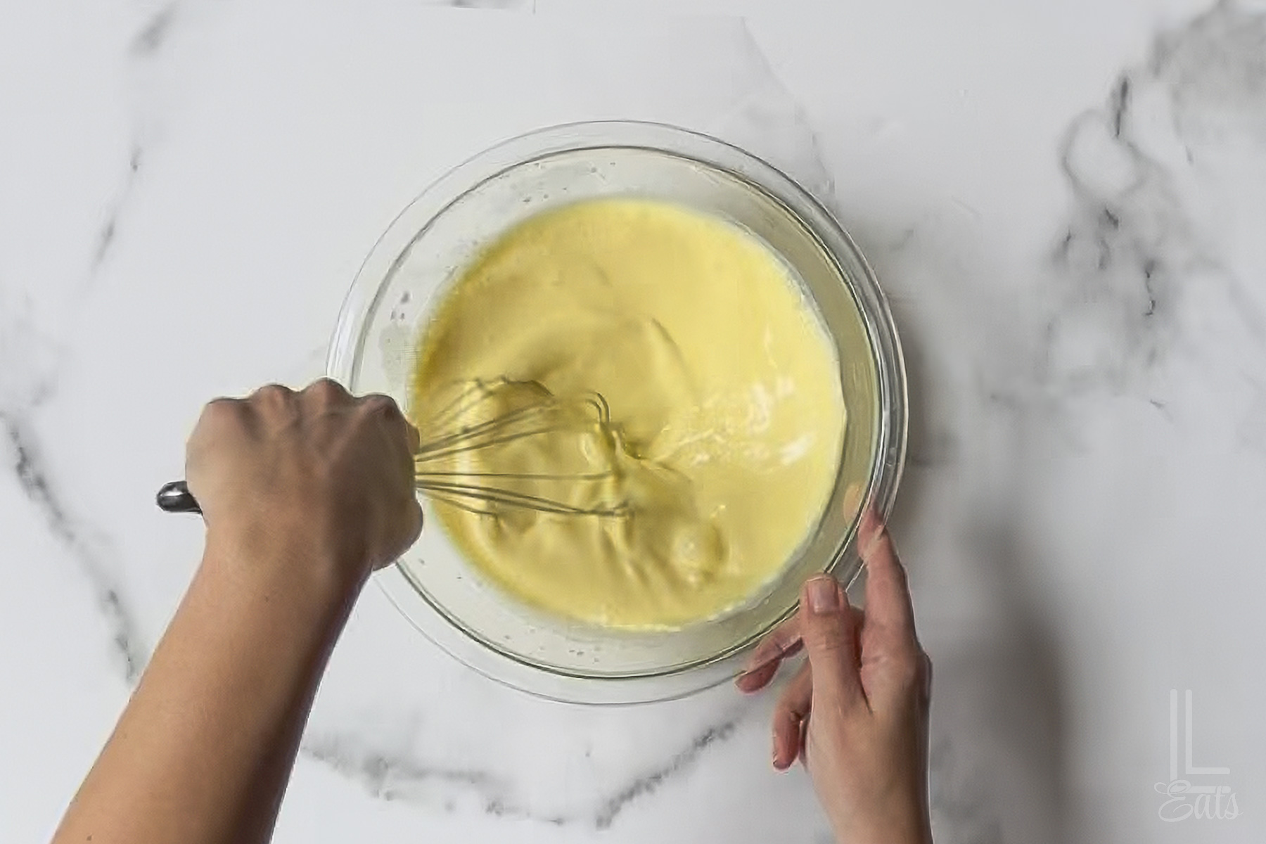 whisking together a pineapple vanilla pudding mix.