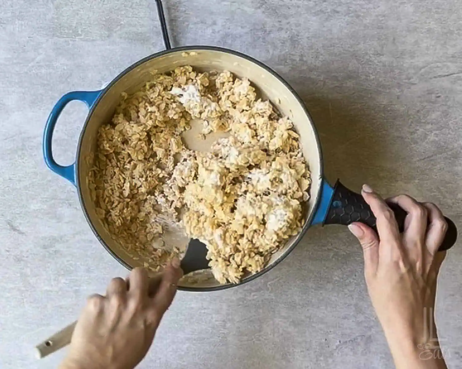 adding rice krispies cereal to the marshmallow fluff/butter mixture.