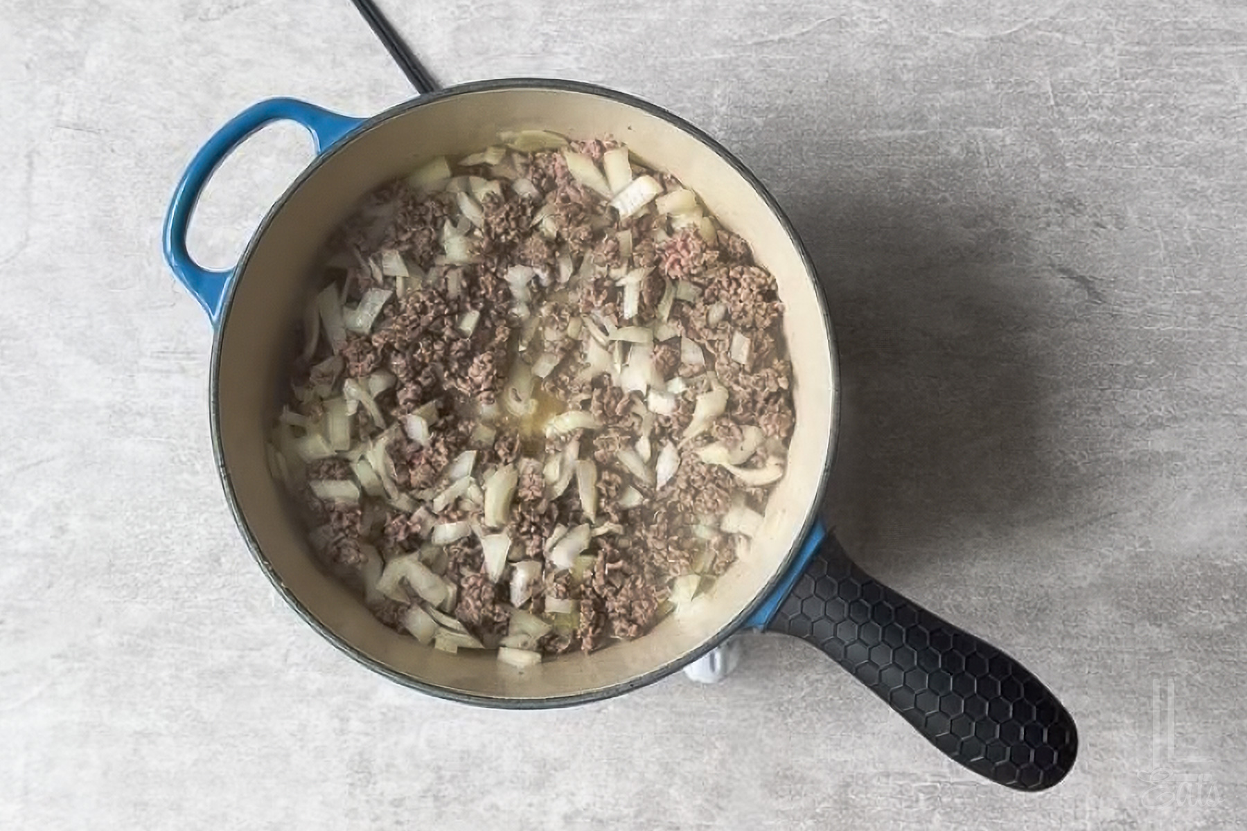 ground beef and onion cooking in a large skillet.