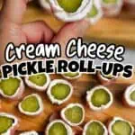 Cream cheese pickle roll-ups with green pickle filling and bacon on a wooden board.