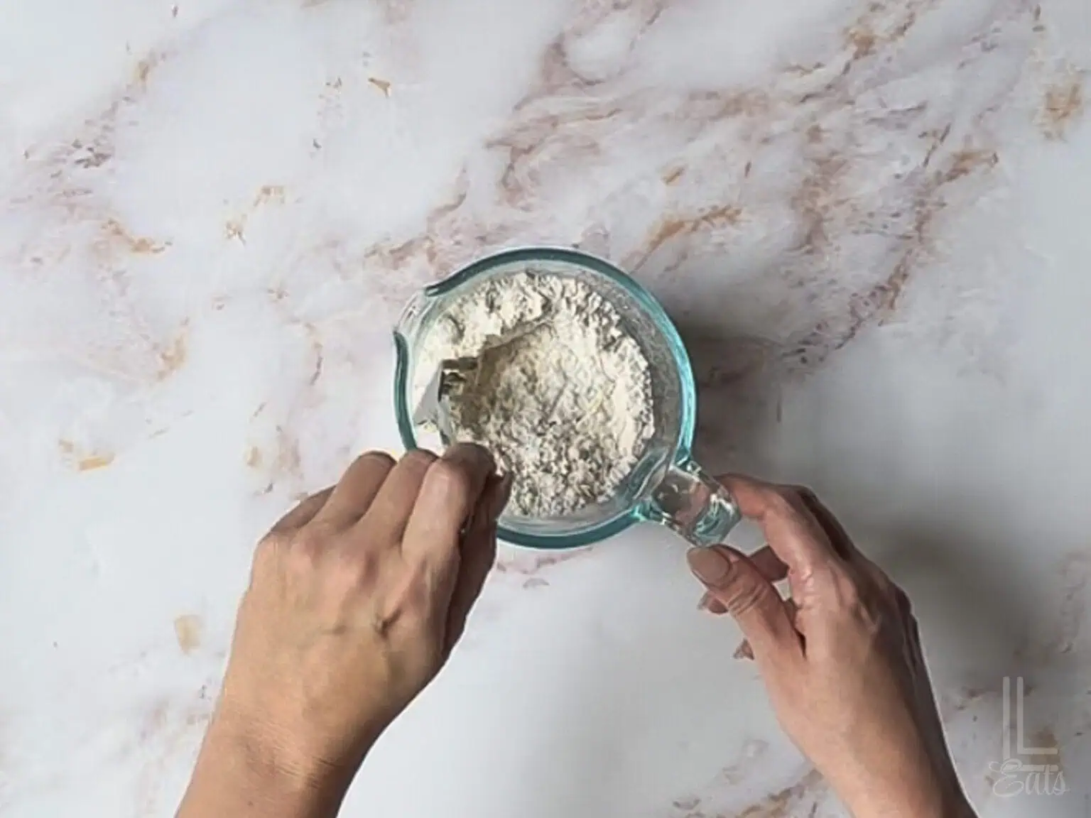 stirring together all purpose flour and baking soda in a measuring cup.