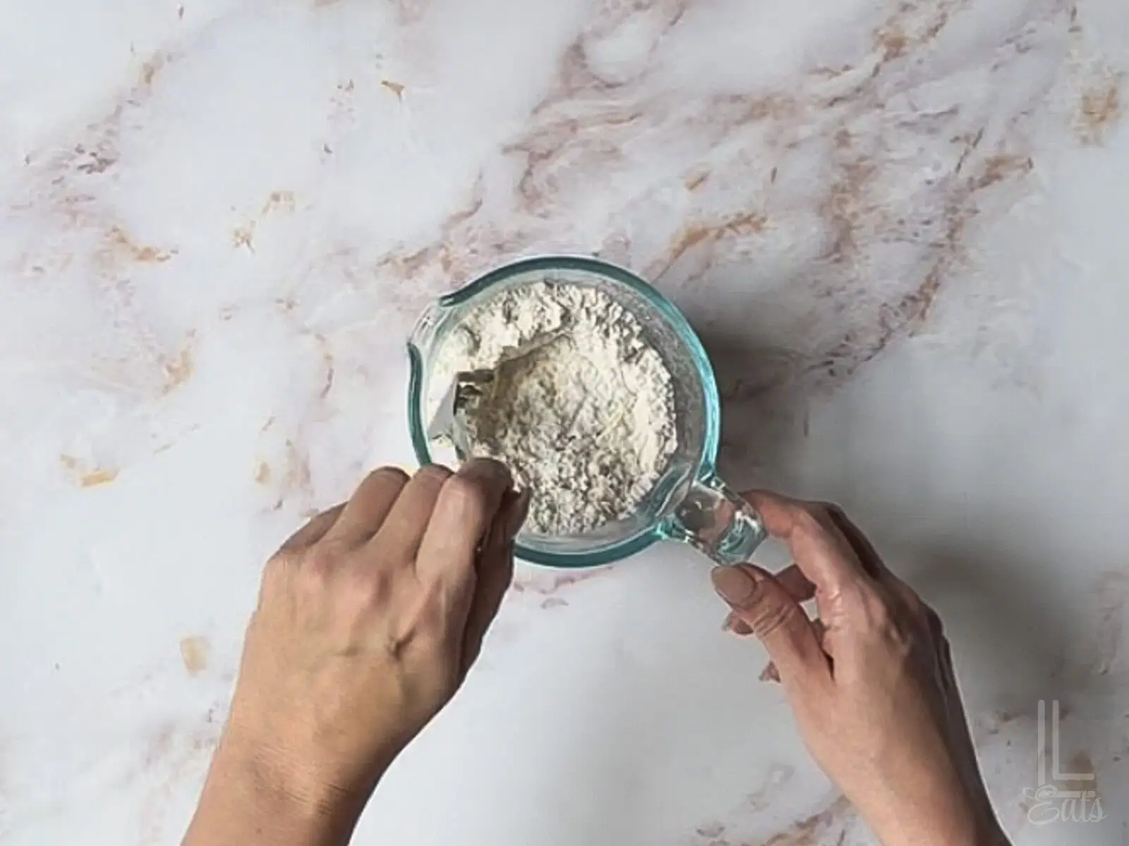 stirring together all purpose flour and baking soda in a measuring cup.