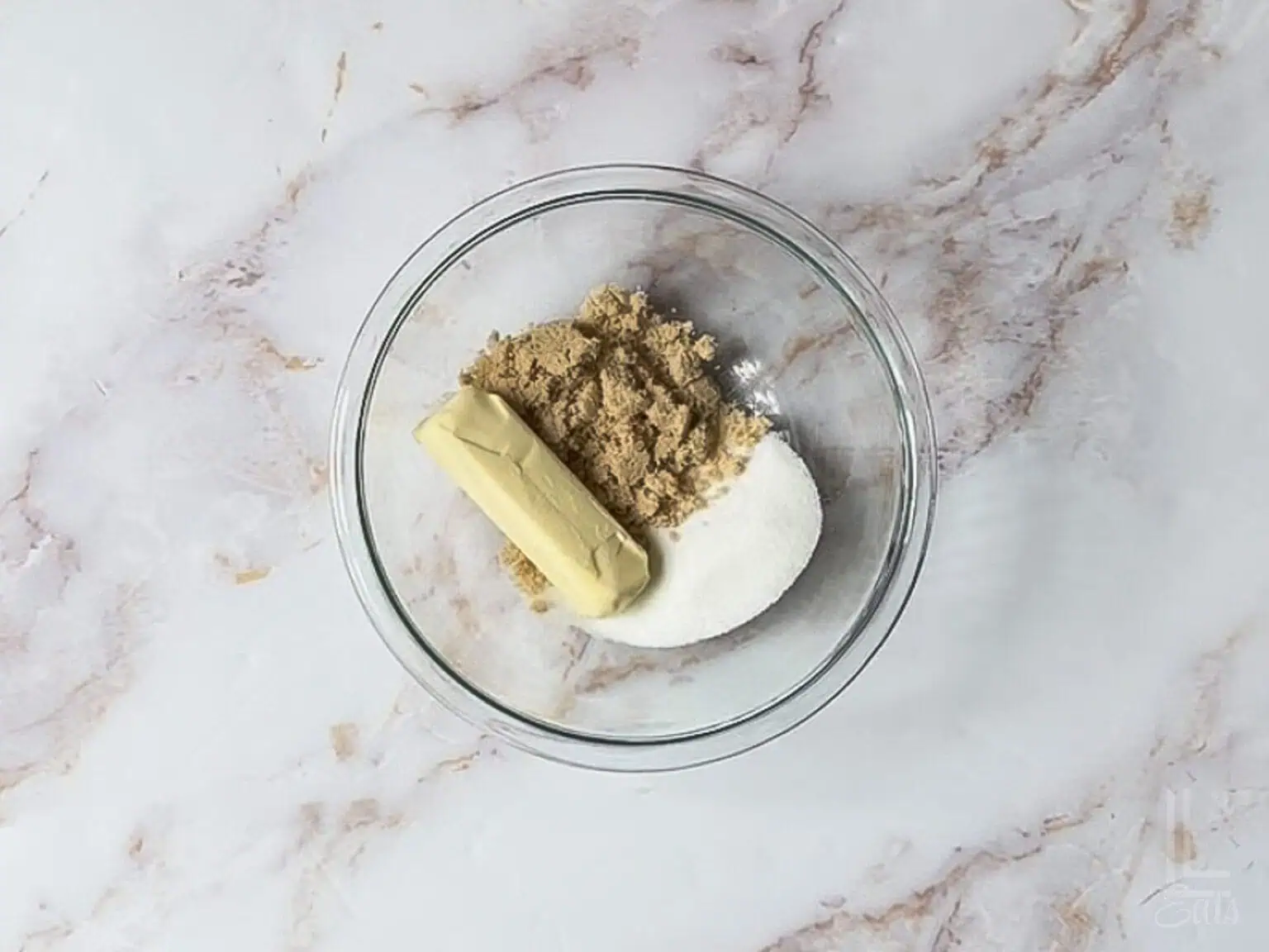 butter, brown sugar, and white sugar in a bowl.