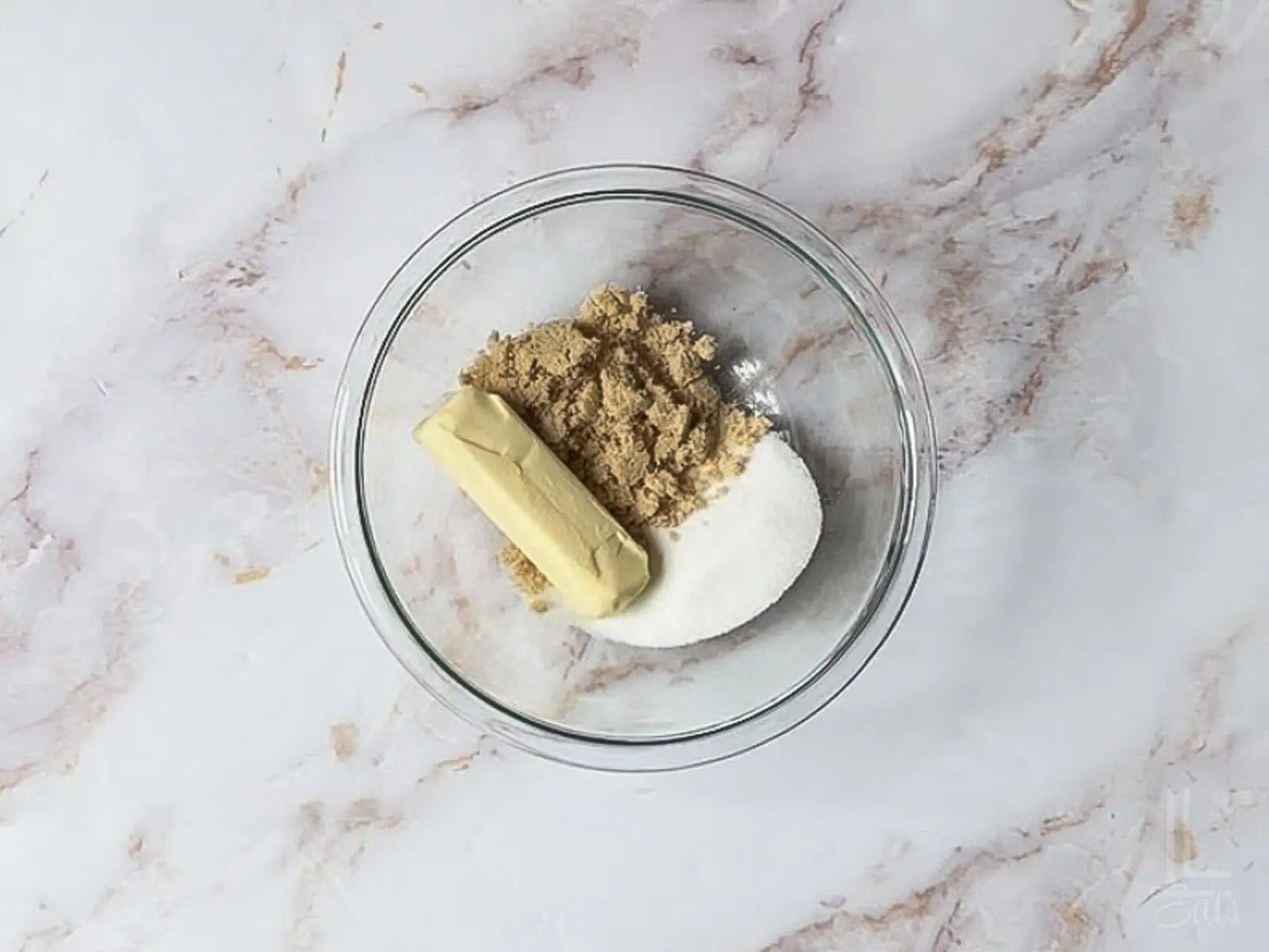 butter, brown sugar, and white sugar in a bowl.