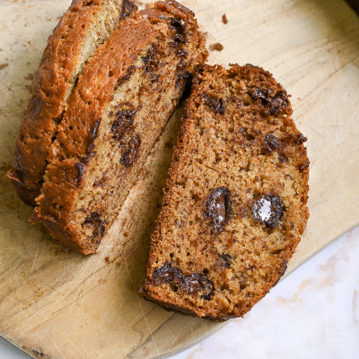 chocolate chip banana bread sliced on a cutting board.
