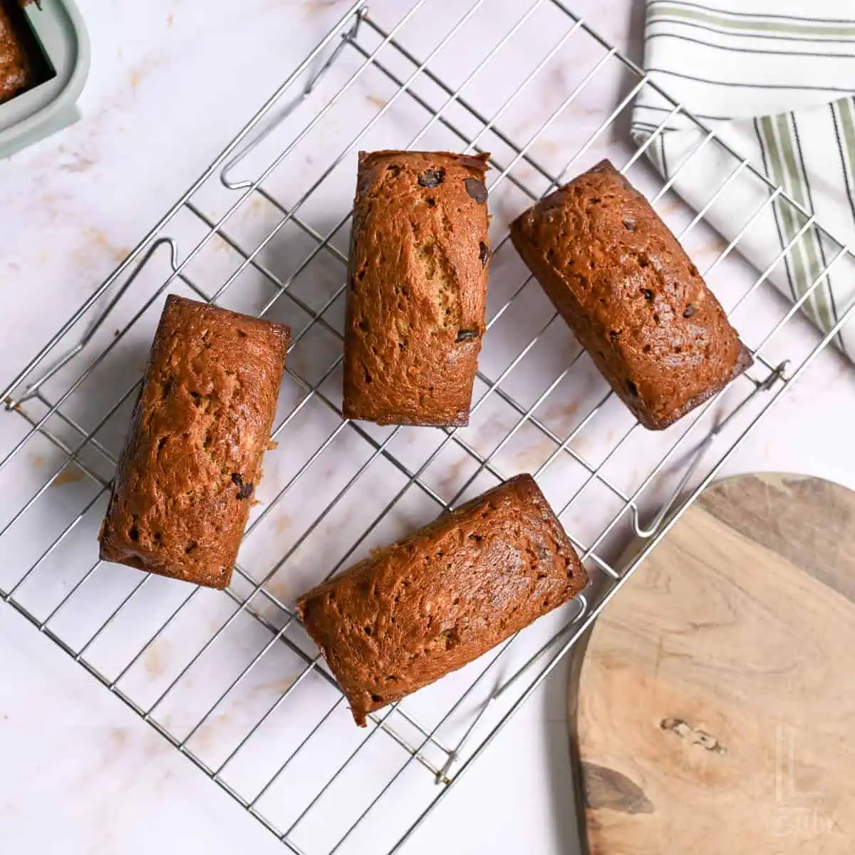 mini loaves of chocolate chip banana bread on a cutting board.
