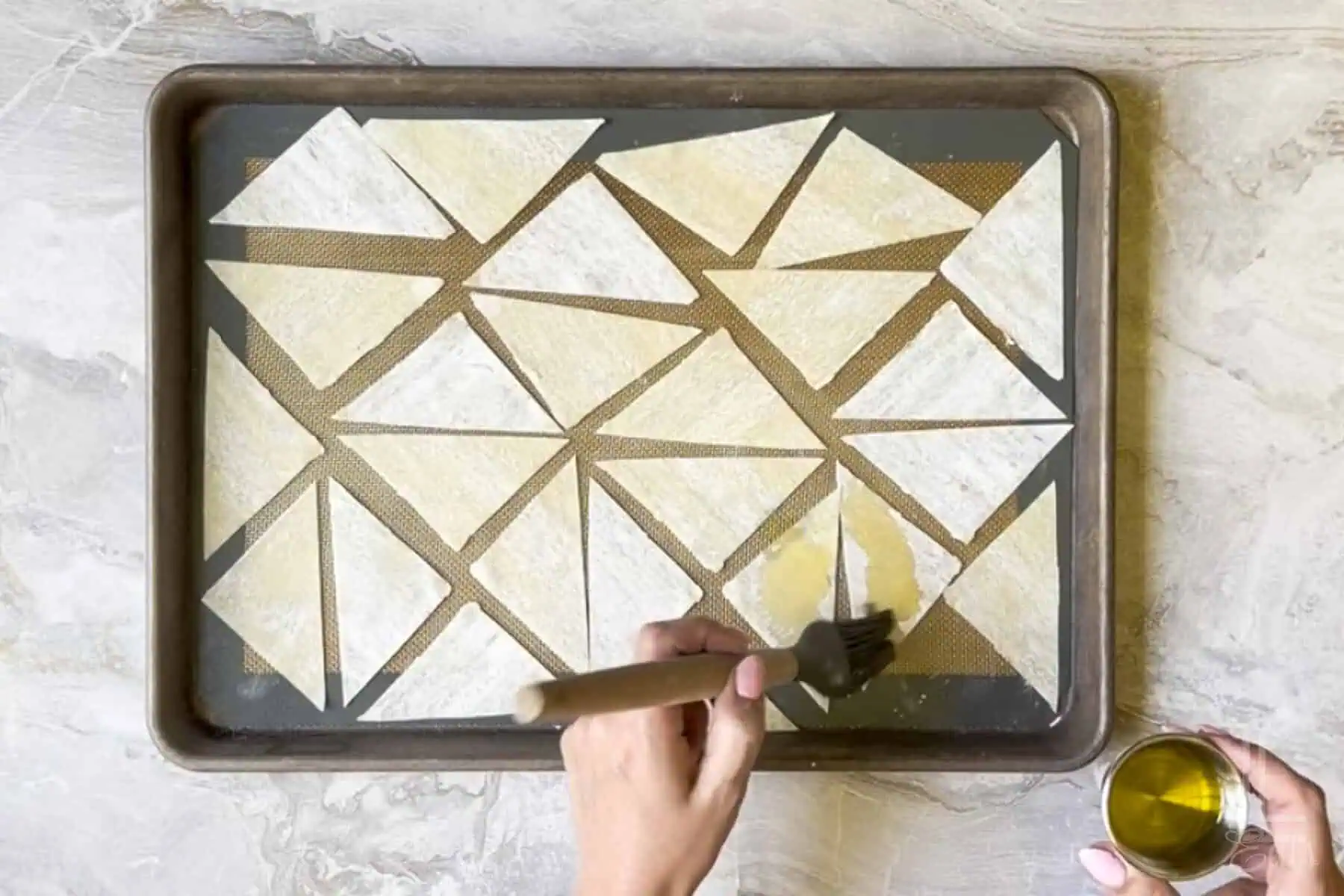 brushing olive oil on the wonton wrappers, before baking.