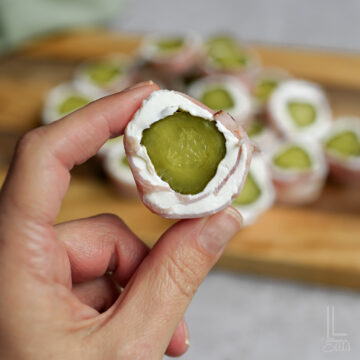 holding a pickle roll up.