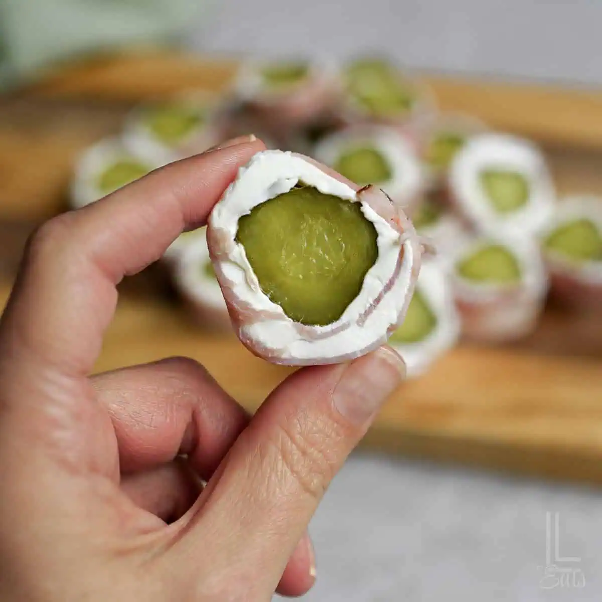 holding a pickle roll up.