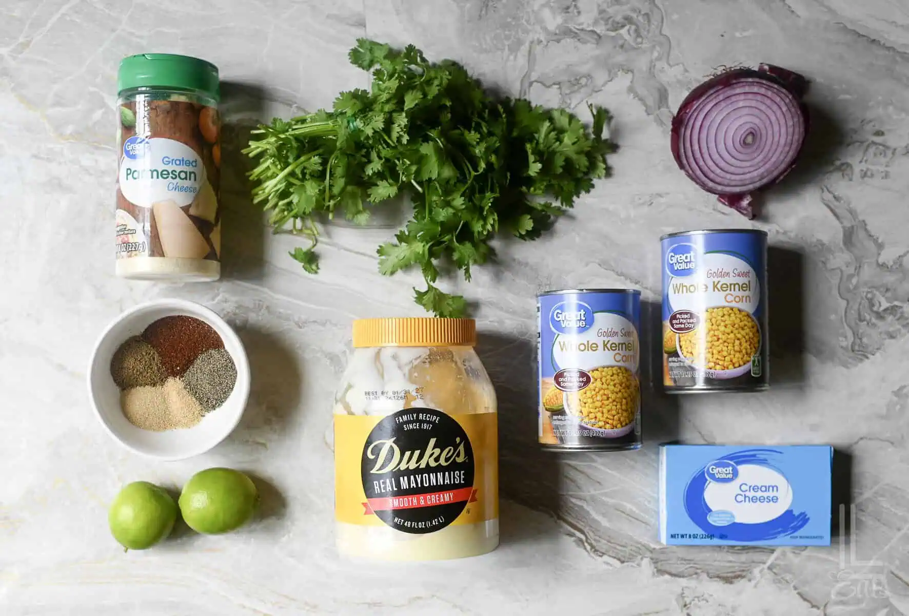 ingredients for elote (mexican street corn) dip, including mayonnaise, canned corn, cilantro, and cream cheese.