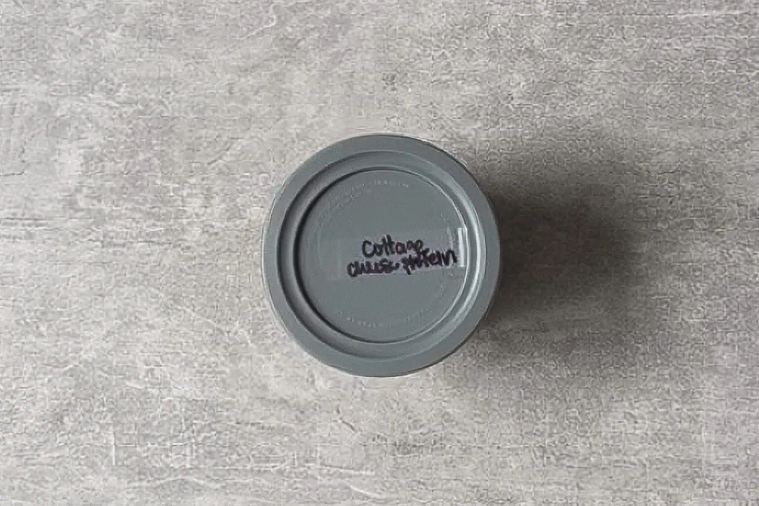 top of a ninja creami ice cream container labeleed with "cottage cheese protein ice cream."