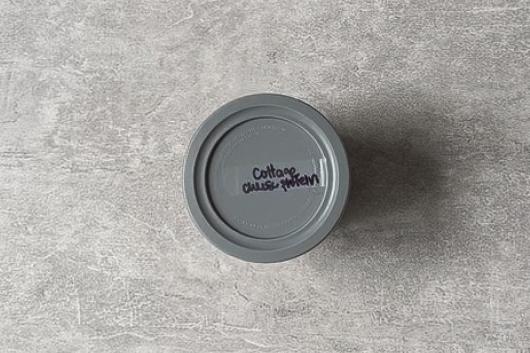 top of a ninja creami ice cream container labeleed with "cottage cheese protein ice cream."