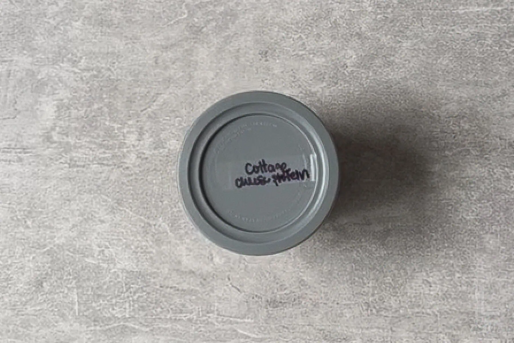 top of a ninja creami ice cream container labeleed with "cottage cheese protein ice cream."