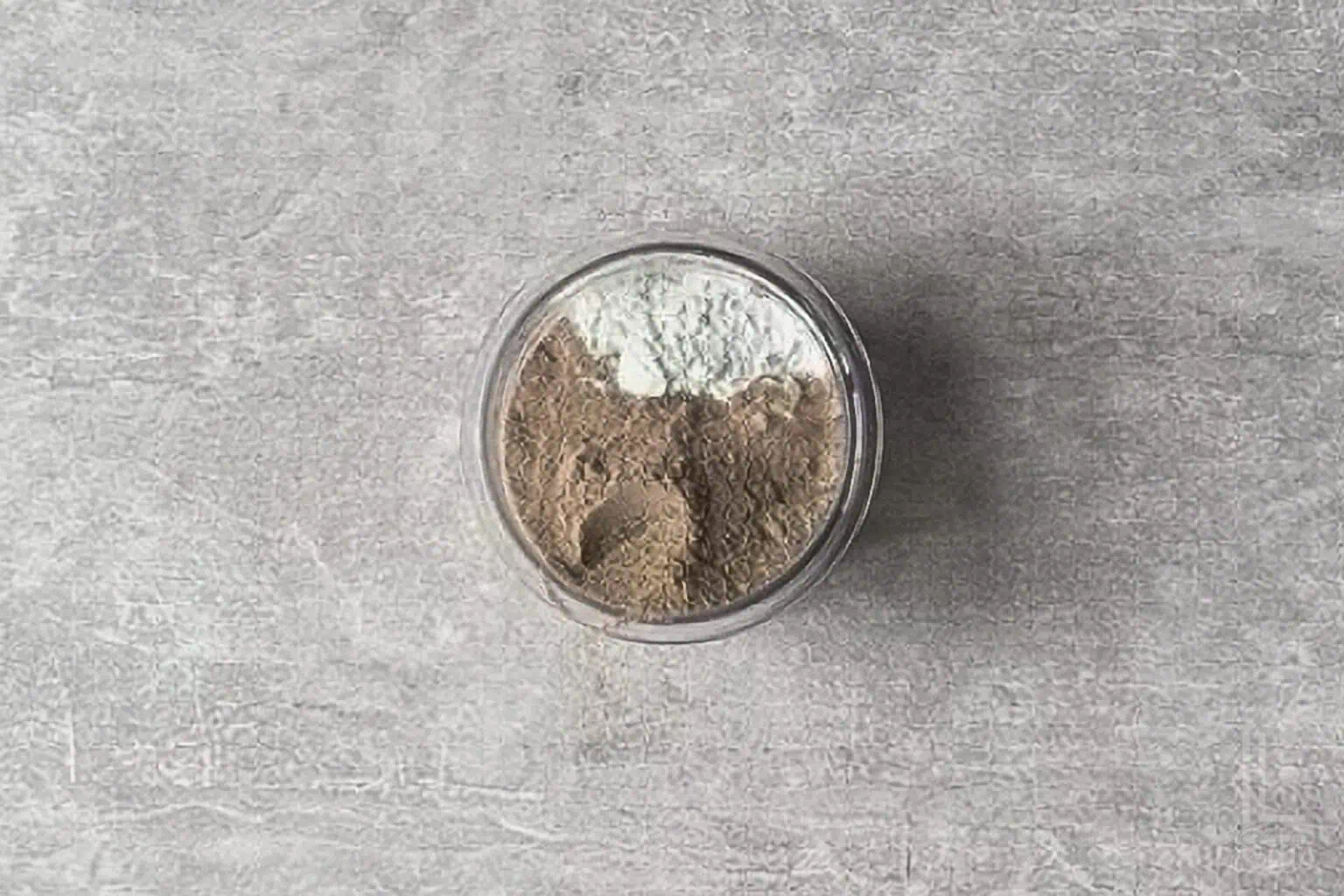 ingredients for cottage cheese protein ice cream (pudding mix, protein powder, and cottage cheese) added to a ninja creami container.