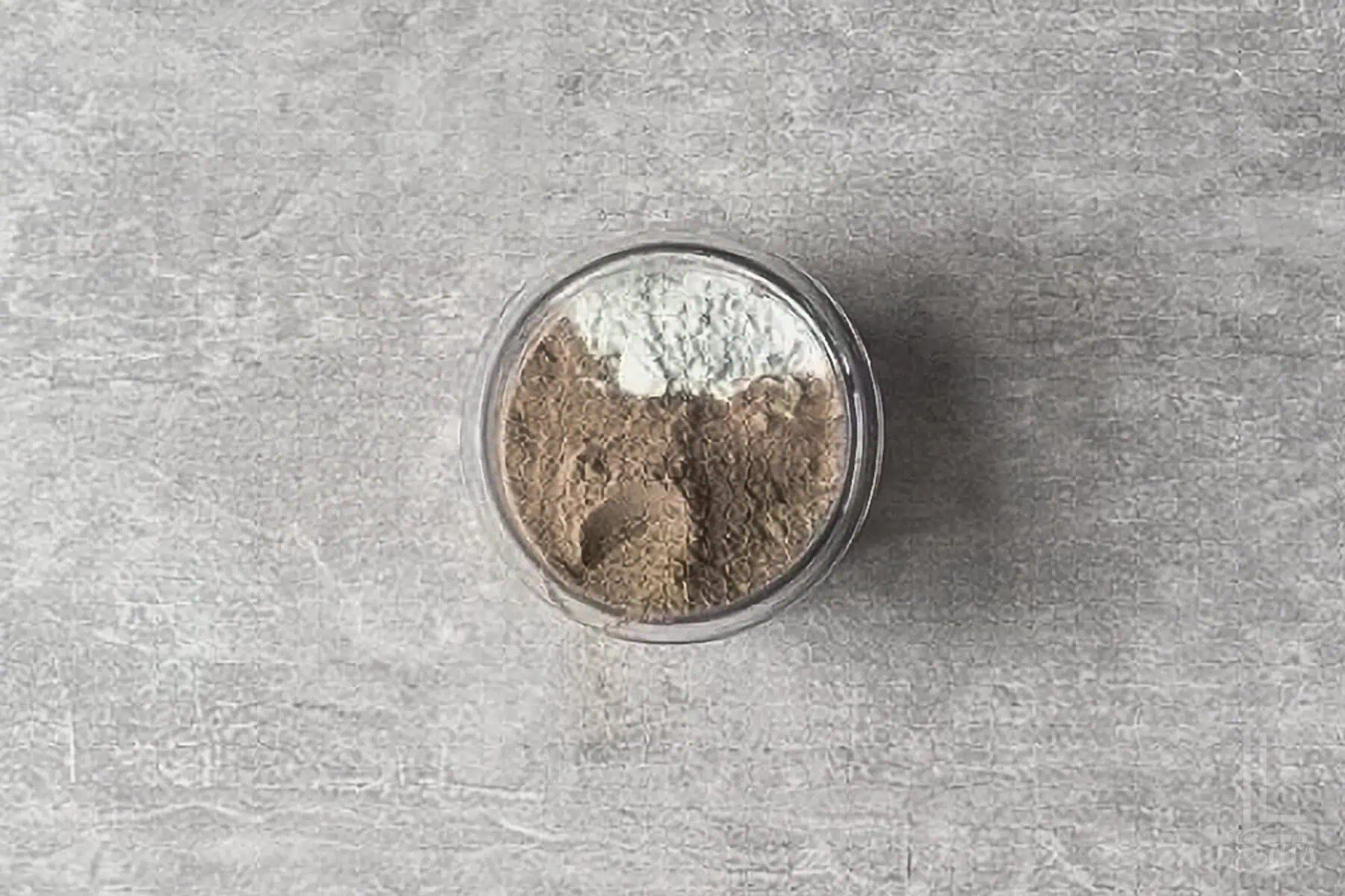 ingredients for cottage cheese protein ice cream (pudding mix, protein powder, and cottage cheese) added to a ninja creami container.