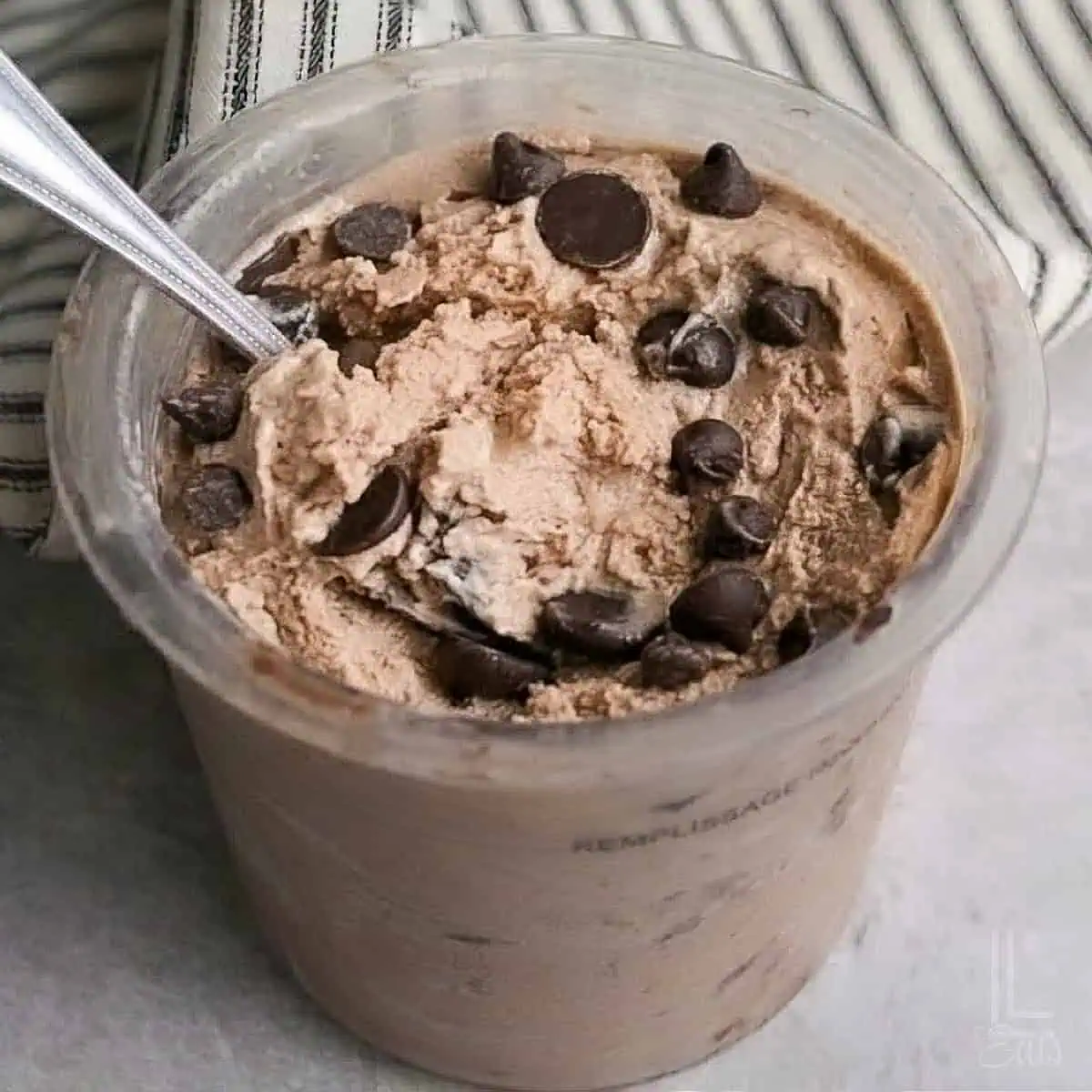 a ninja craemi container of protein ice cream, topped with chocolate chips.