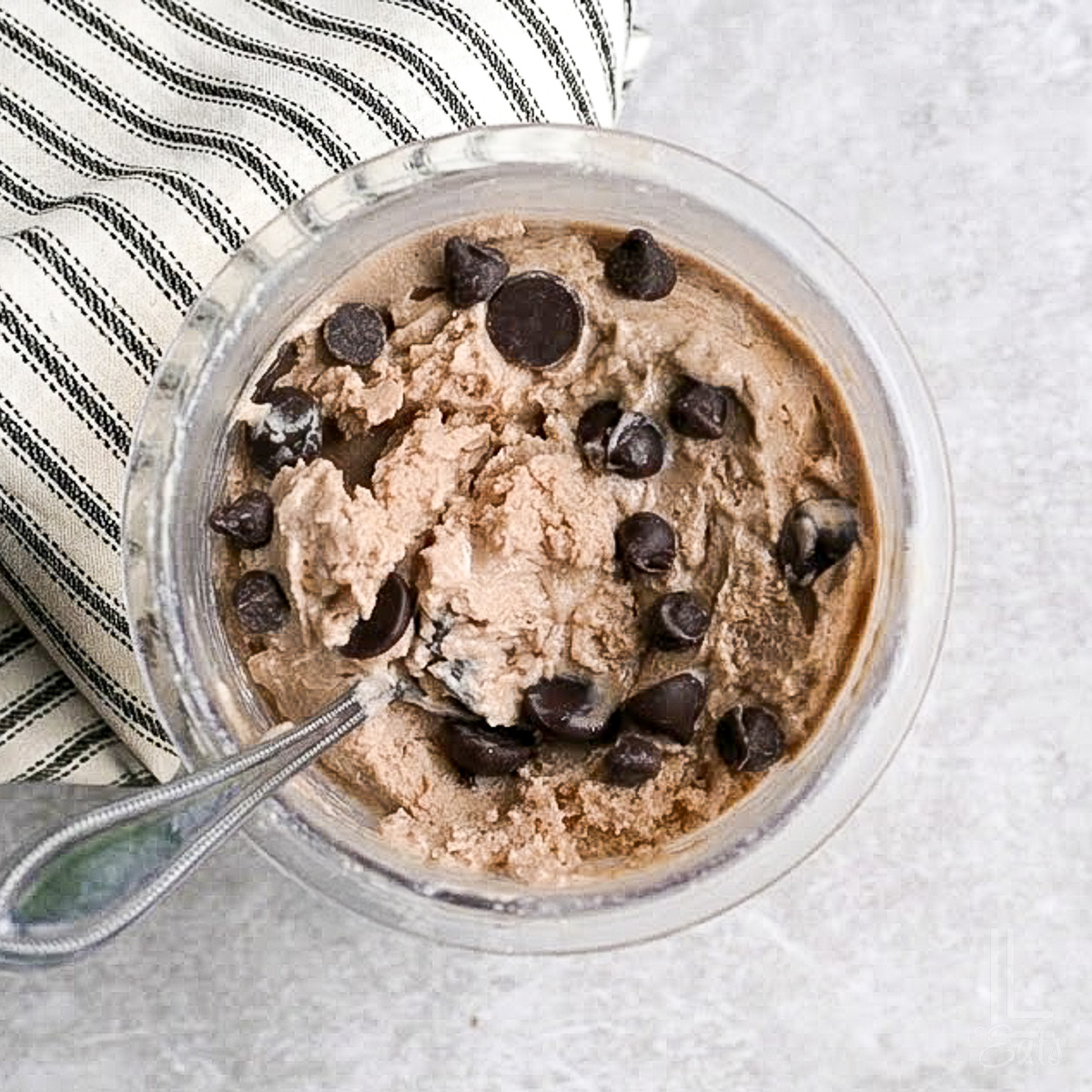 a pint of ninja creami protein ice cream topped with chocolate chips.