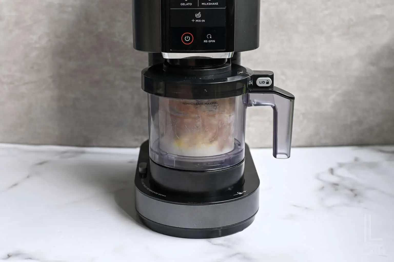 ninja creami protein ice cream in a ninja creami machine, before mixing.