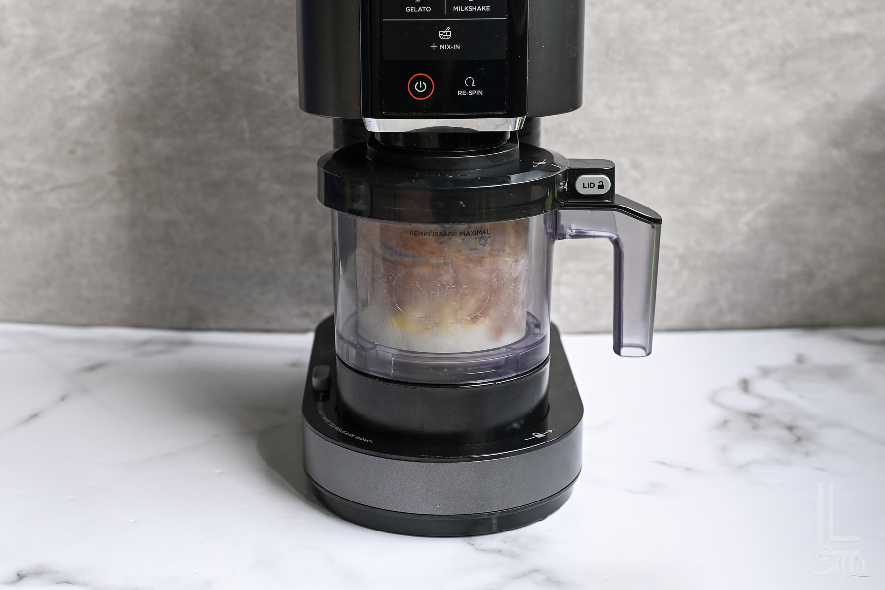 ninja creami protein ice cream in a ninja creami machine, before mixing.