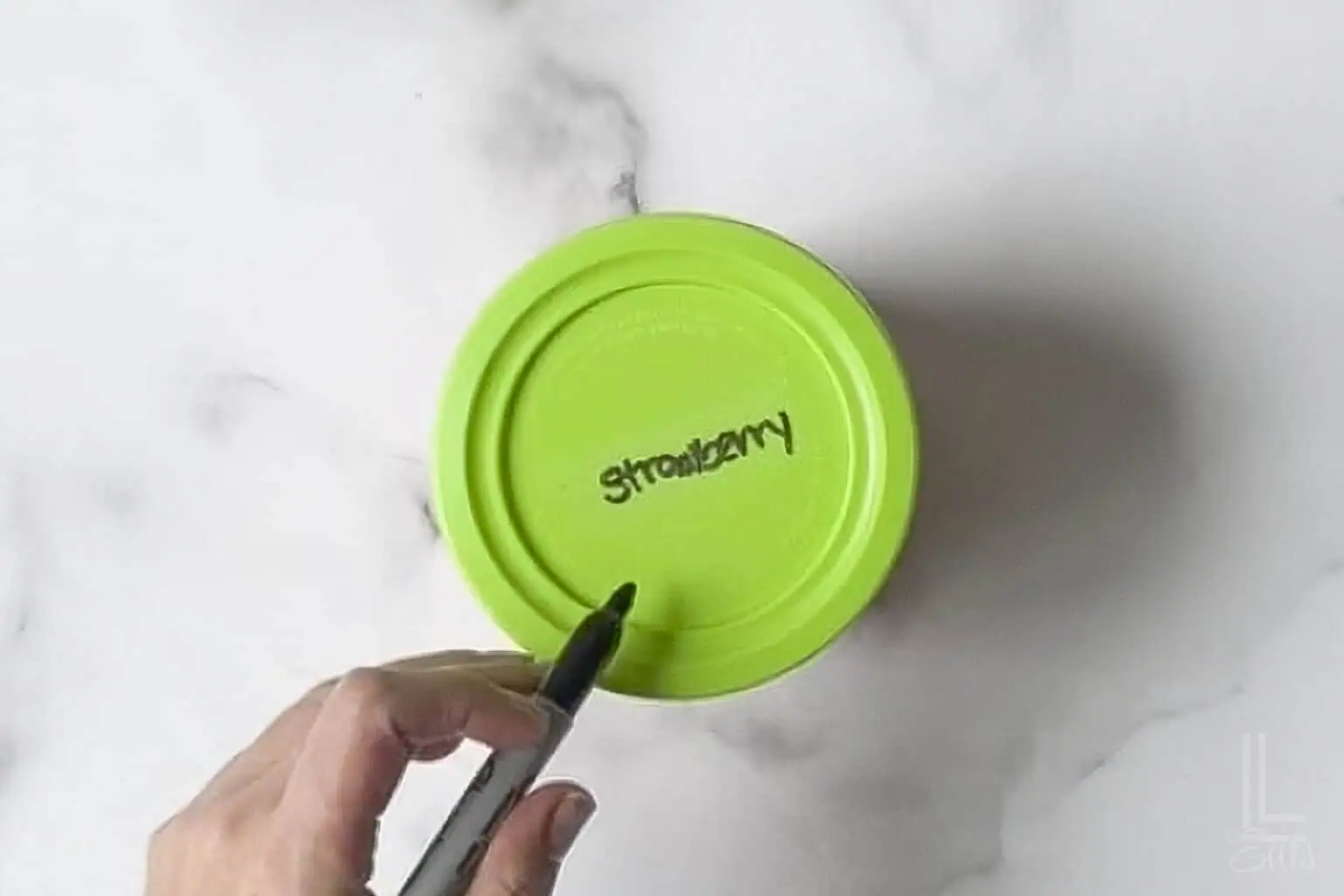 ninja creami container labeled with "strawberry" on the top.