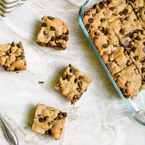 Homemade peanut butter cookie bars with chocolate chips in a glass baking dish.