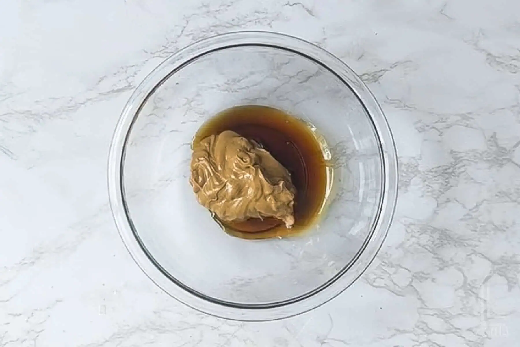peanut butter and maple syrup in a glass bowl.
