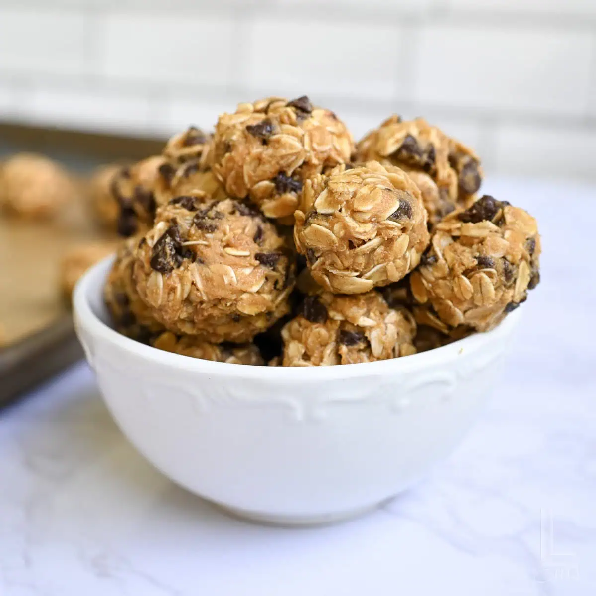 a bowl of peanut butter oatmeal balls with chocolate chips.