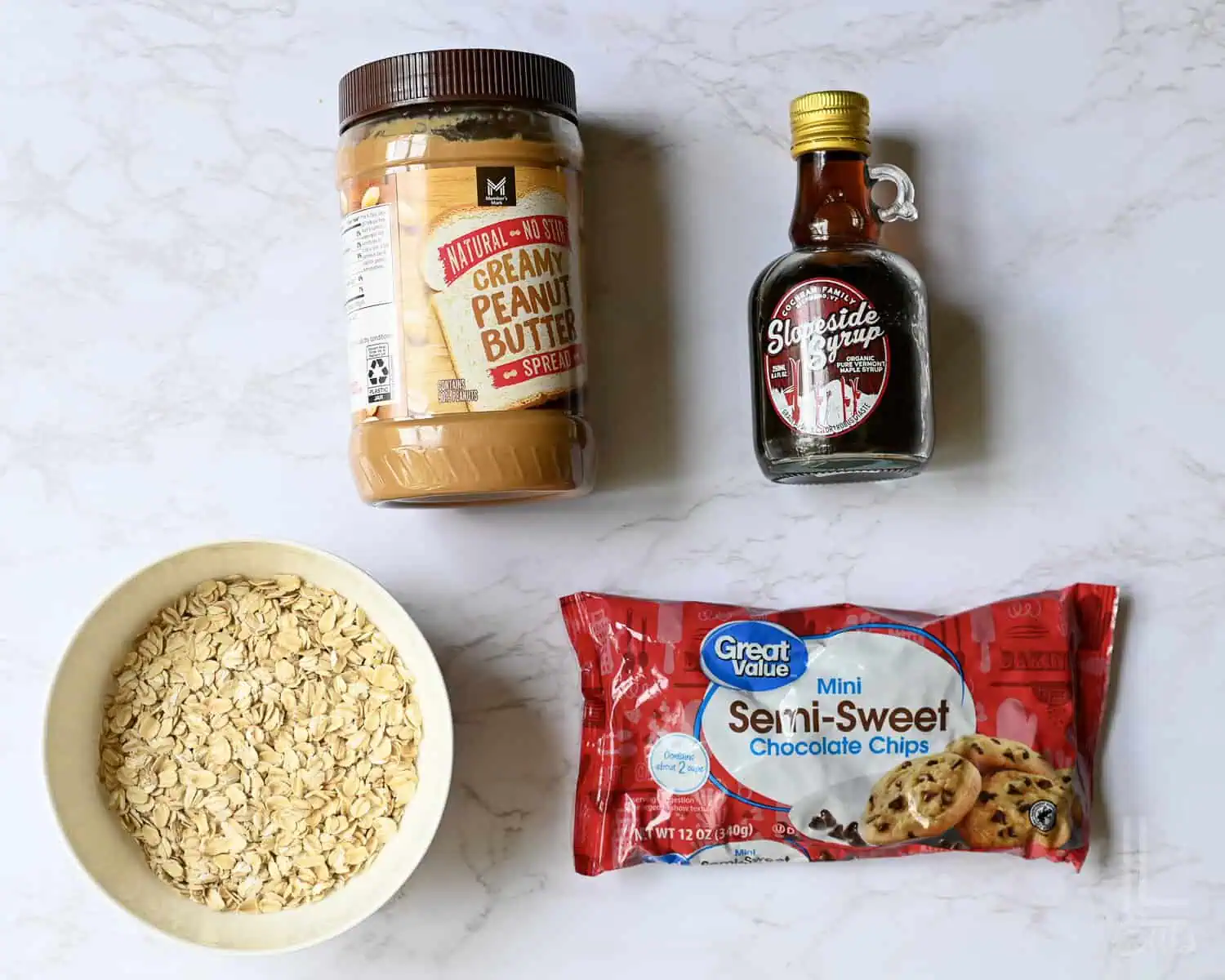 ingredients for peanut butter balls; oatmeal, no-stir peanut butter, chocolate chips, and maple syrup