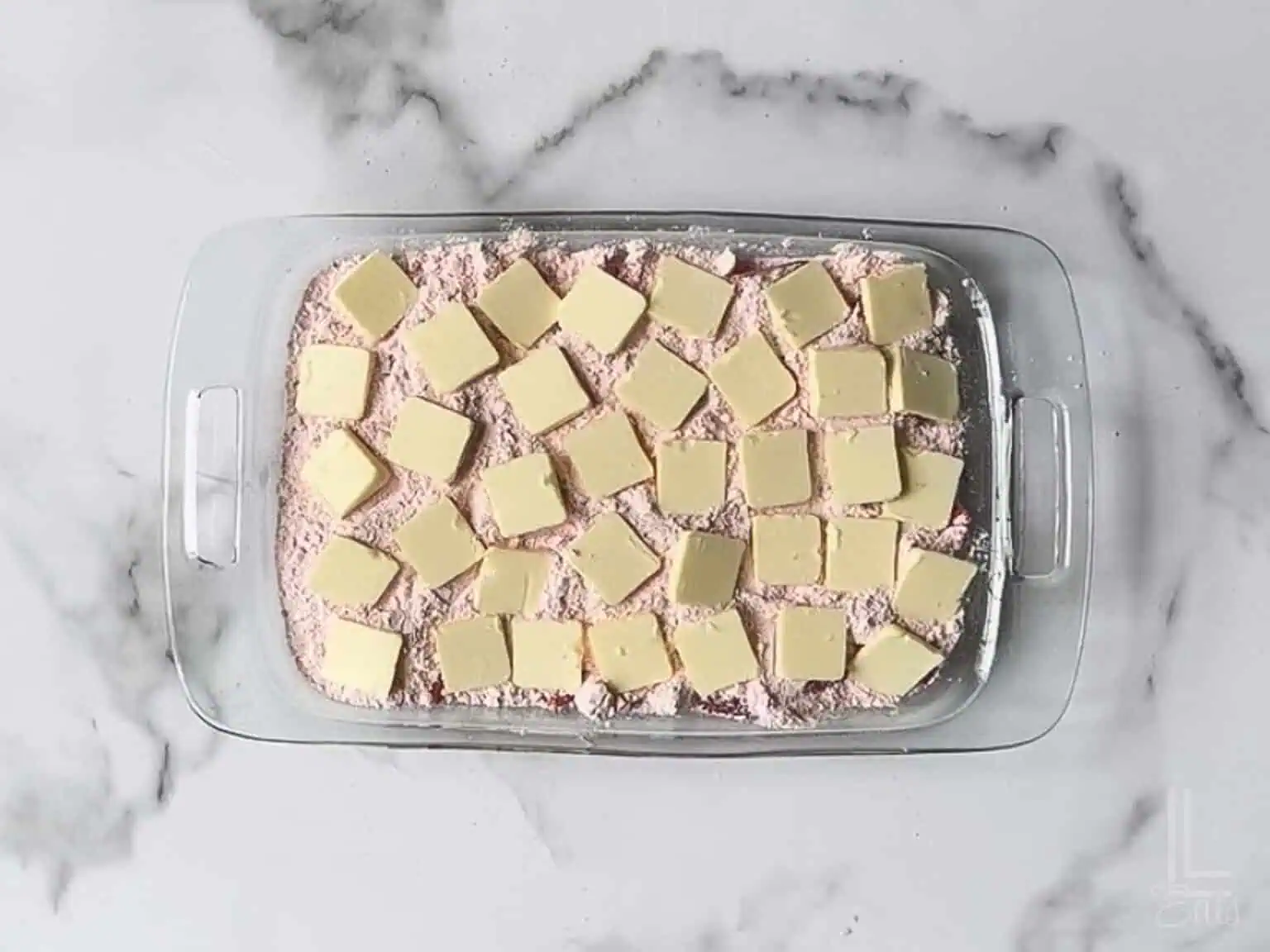 thin pats of cold butter scattered over the dry cake mix.