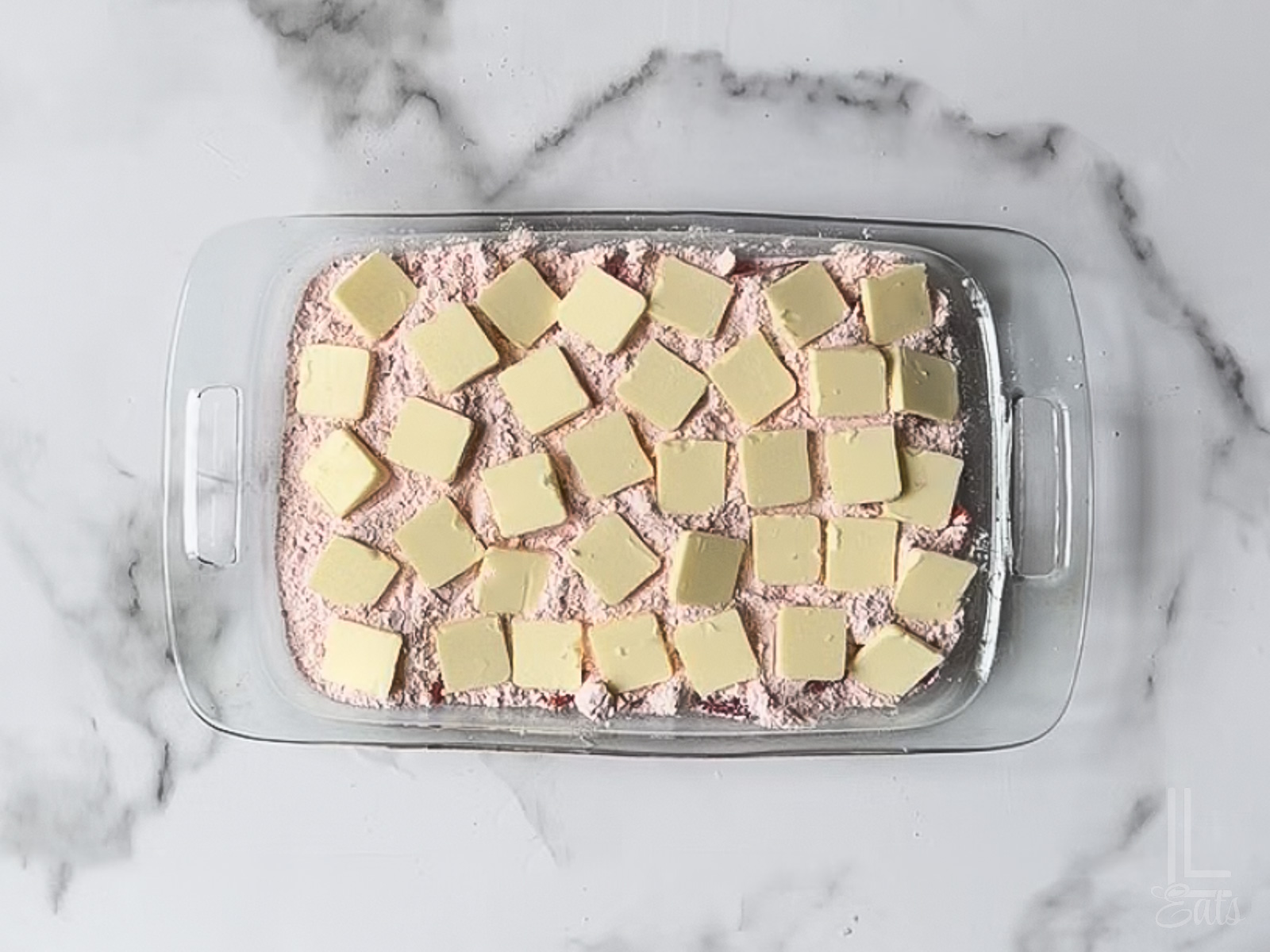 thin pats of cold butter scattered over the dry cake mix.