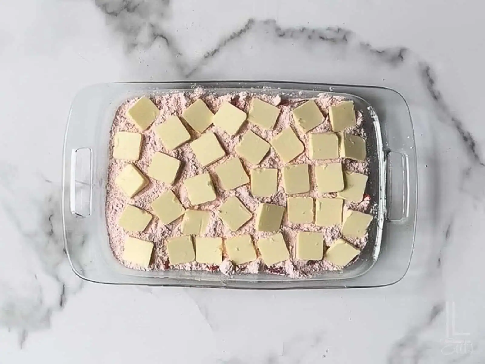 thin pats of cold butter scattered over the dry cake mix.