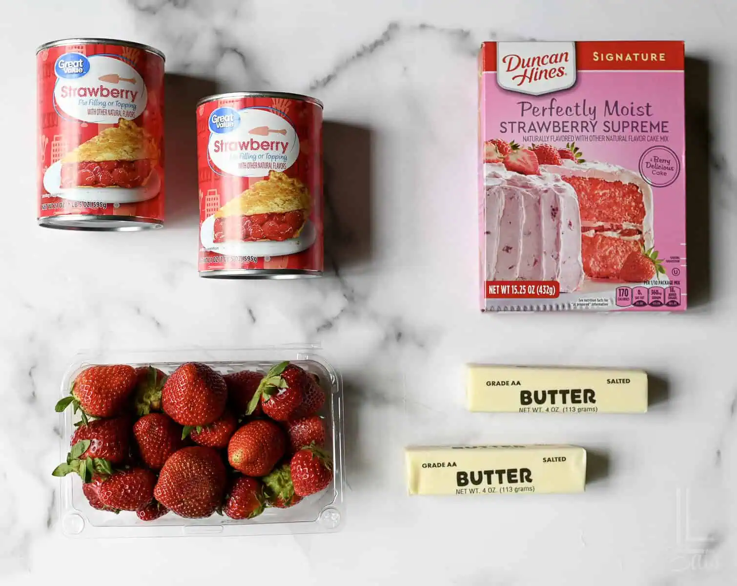 ingredients for strawberry dump cake - cake mix, strawberries, pie filling, and butter.