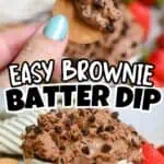 Close-up of a cookie with brownie batter dip and chocolate chips, strawberries in background.