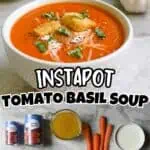 Bowl of fresh tomato basil soup with croutons and herbs, ingredients nearby.