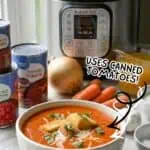 Instant Pot tomato soup with canned tomatoes, onion, and carrots on a kitchen counter.