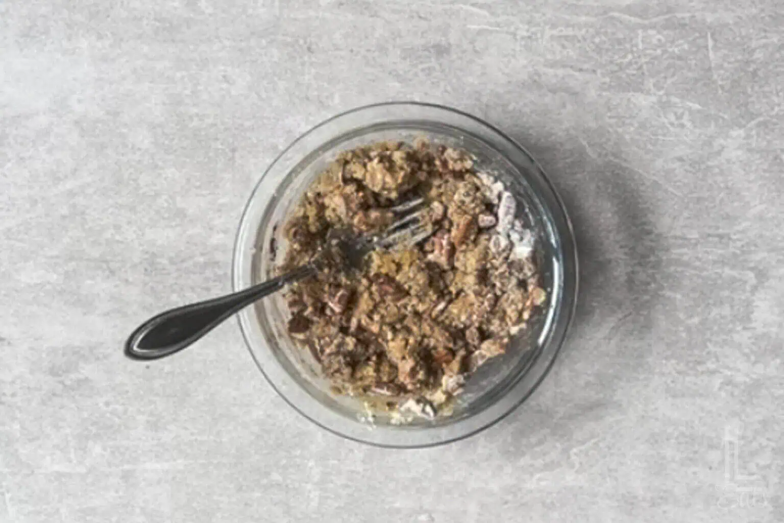 blending the pecan crumble mixture in a small bowl with a fork.