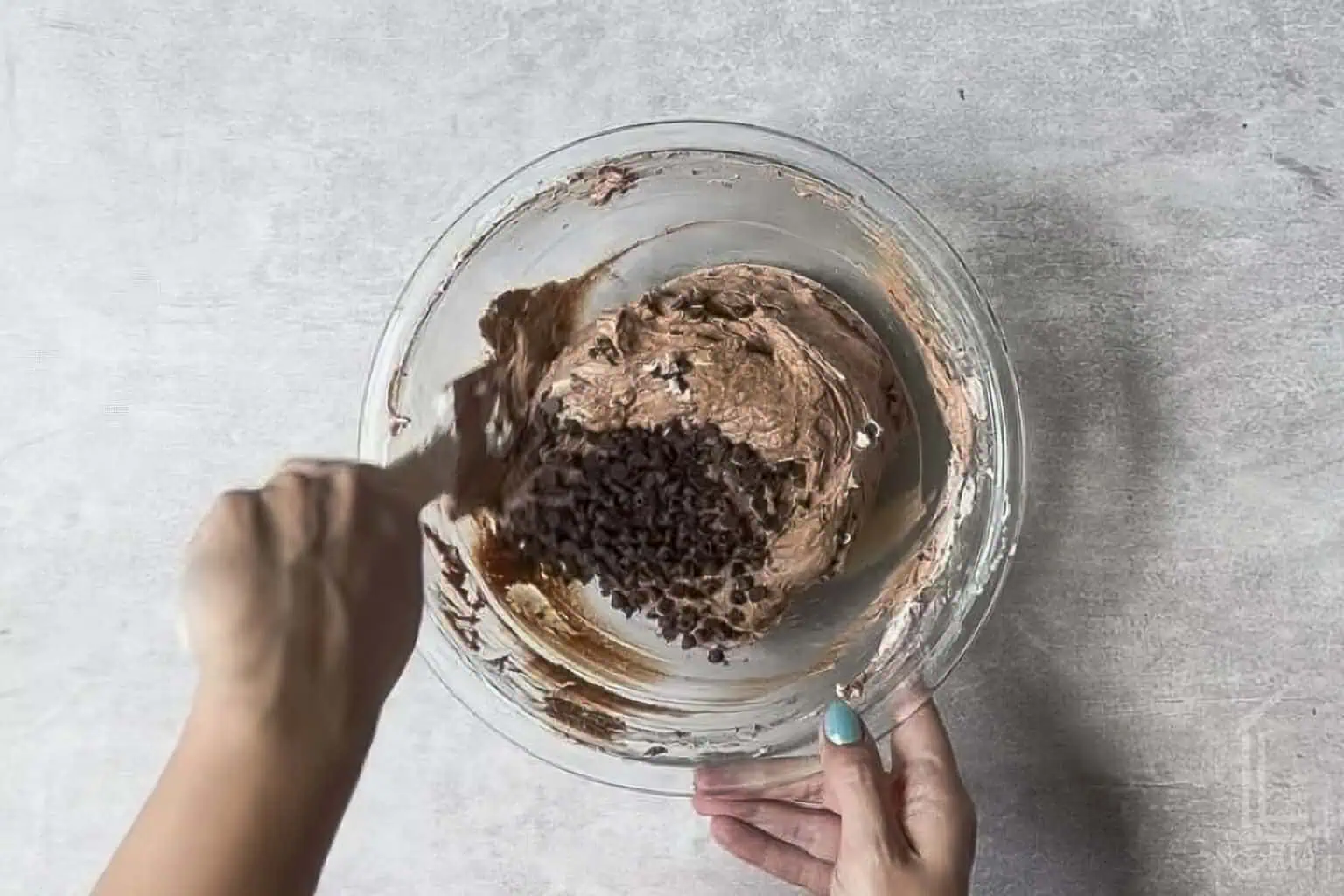folding mini chocolate chips into the brownie batter dip.