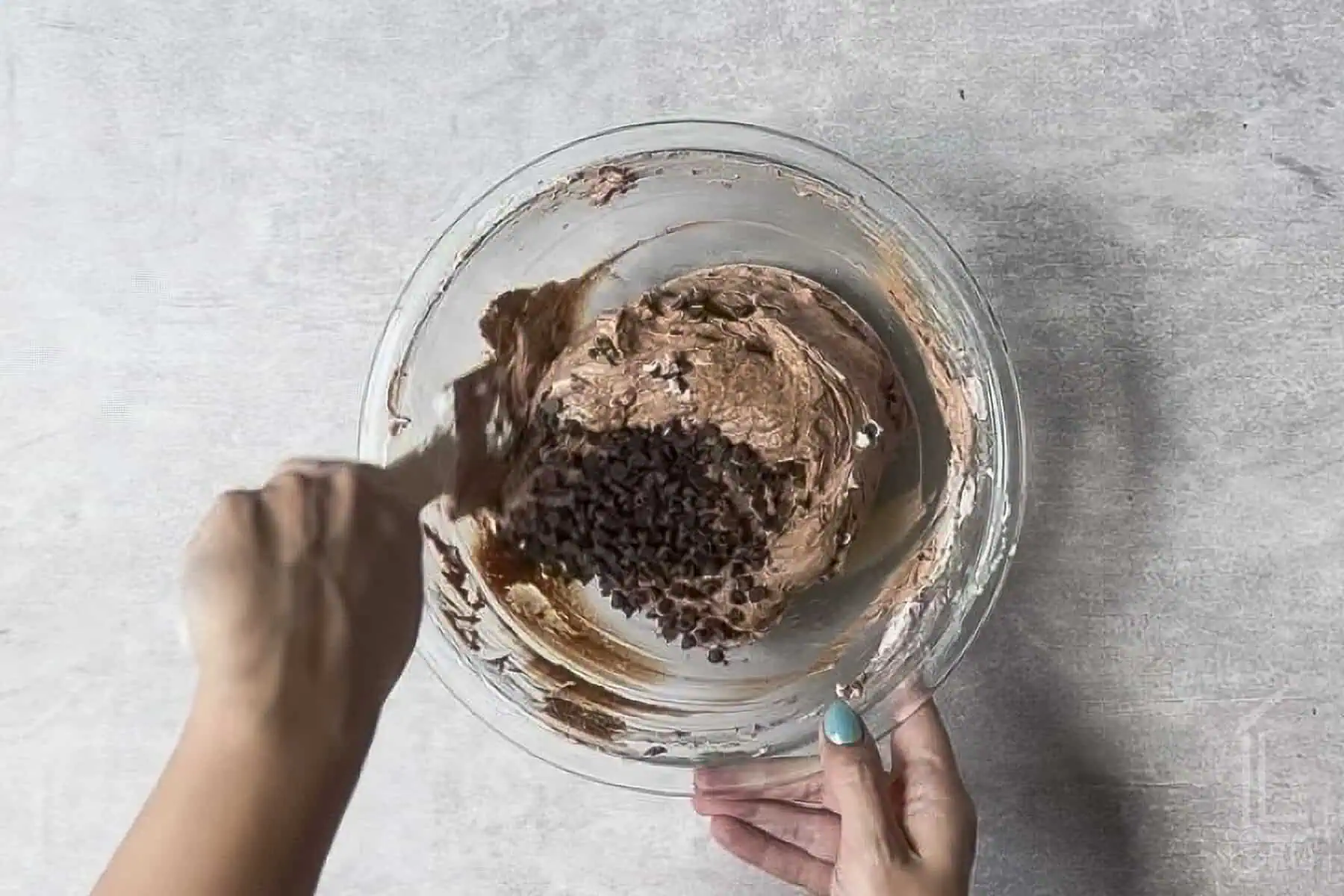 folding mini chocolate chips into the brownie batter dip.