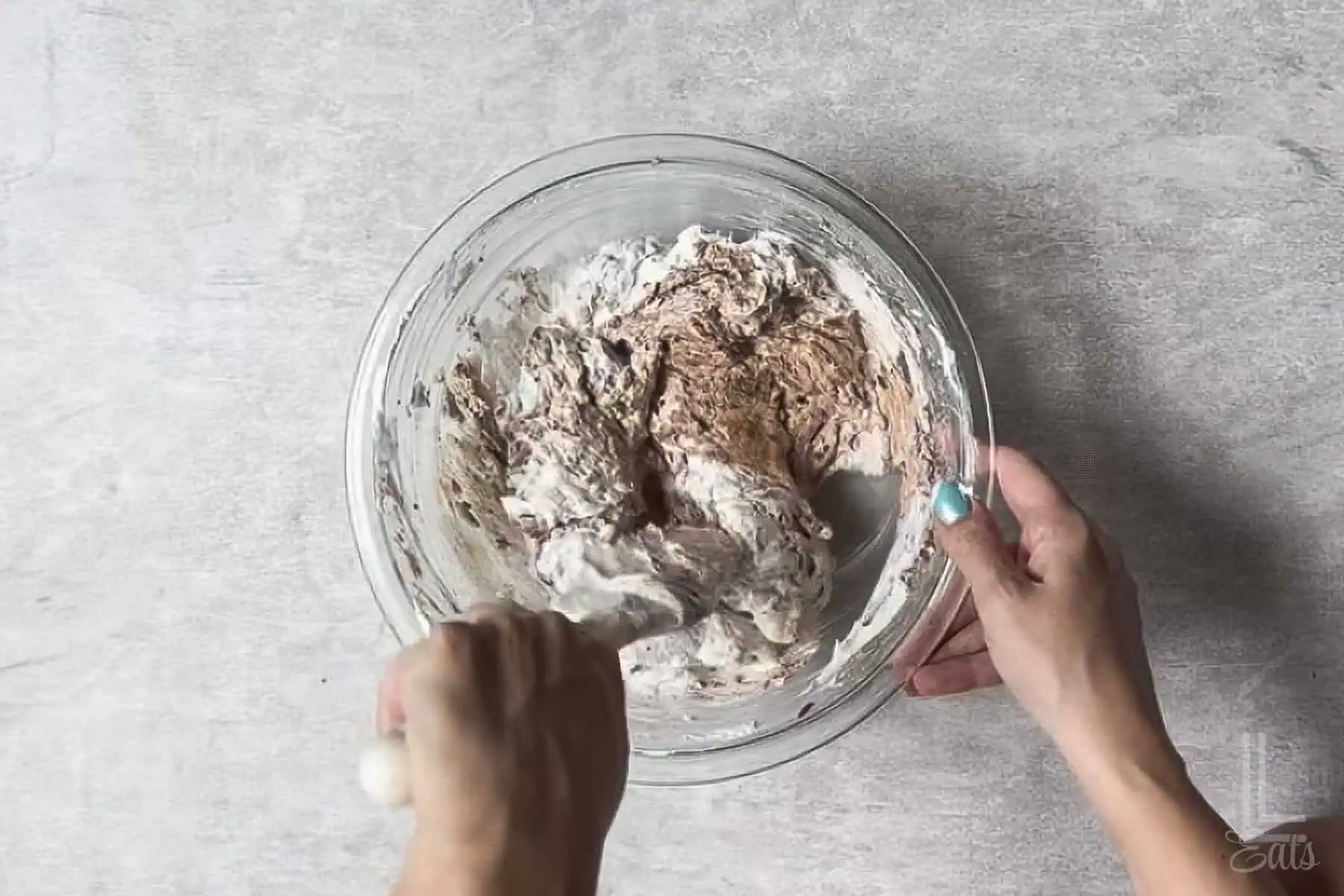 folding whipped topping into the brownie batter dip mixture.