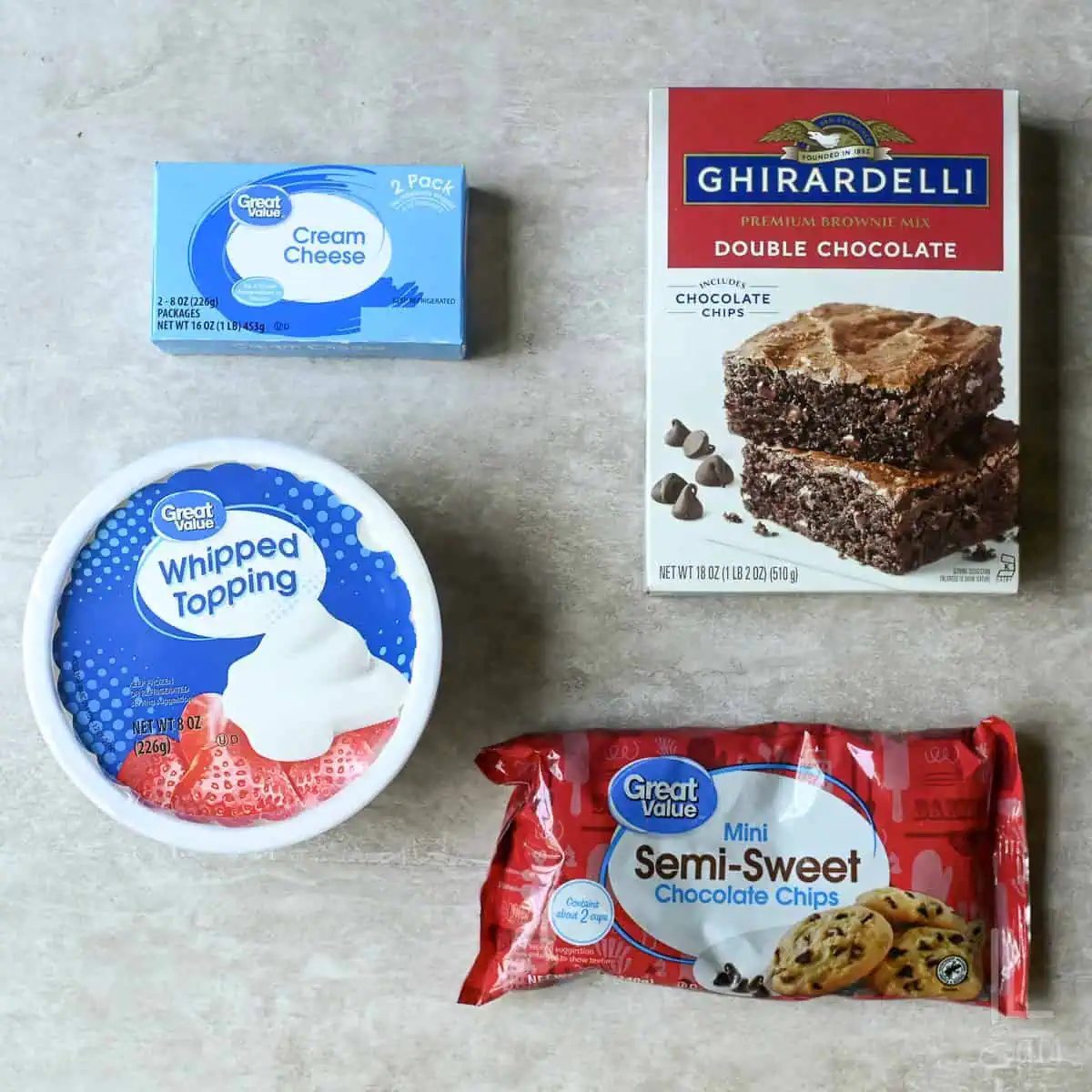 4 ingredients for brownie batter dip (brownie mix, cream cheese, whipped topping, and mini chocolate chips).