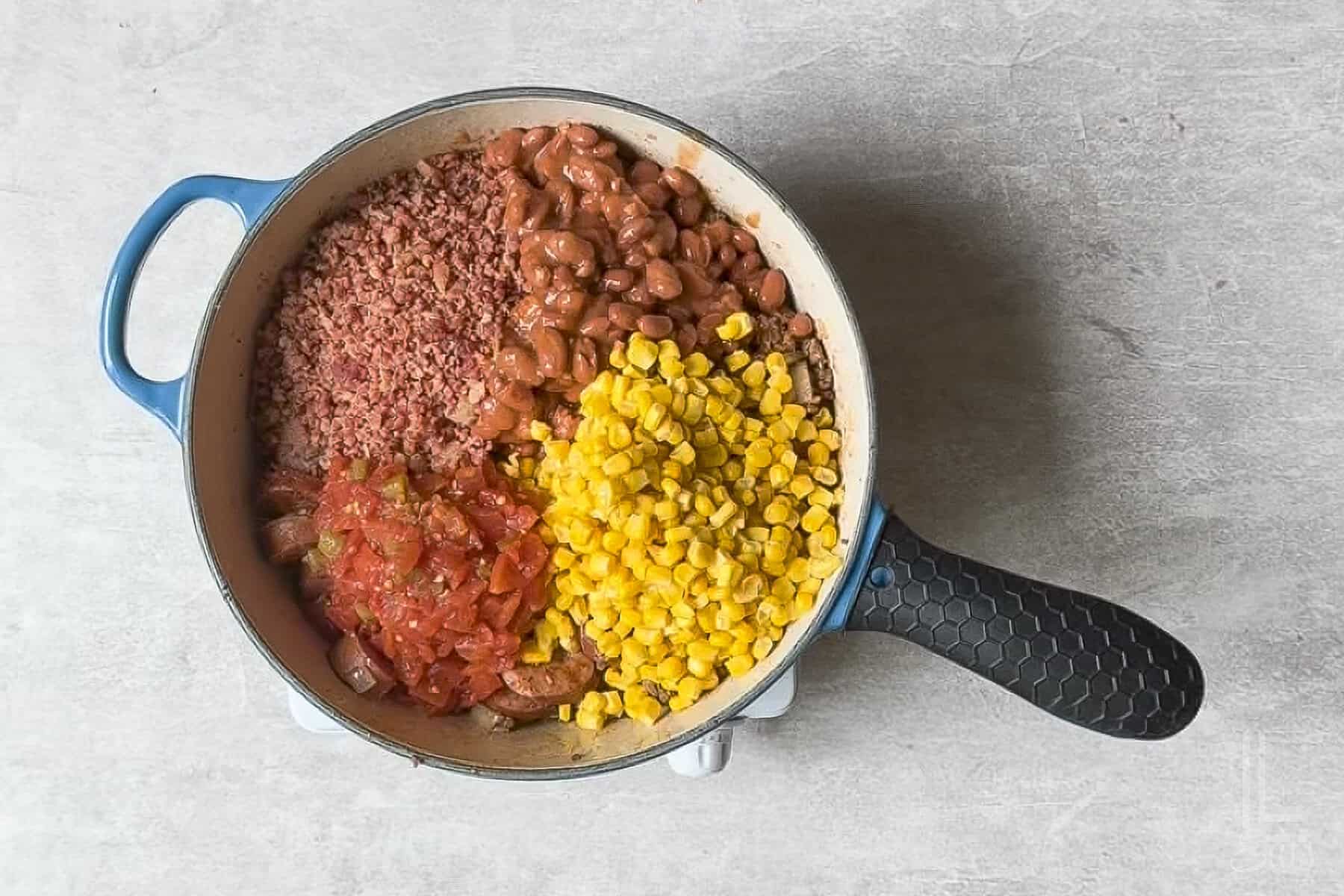 added corn, bacon pieces, rotel, and chili beans to the pot.