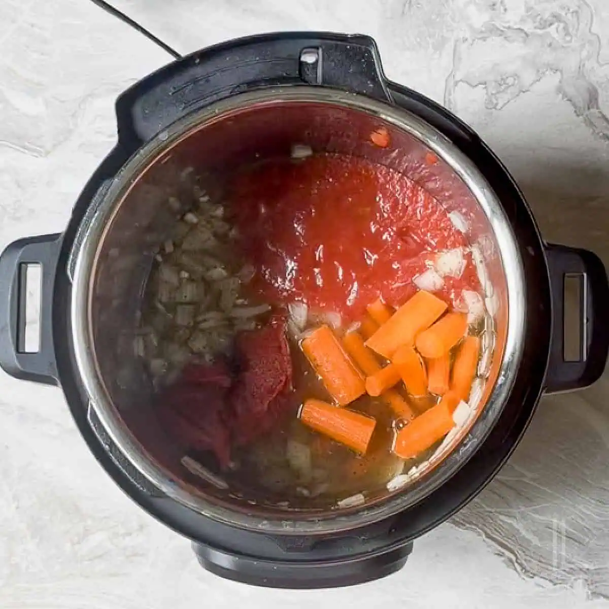 carrots, tomato sauce, and diced tomatoes added to the instant pot tomato soup base.