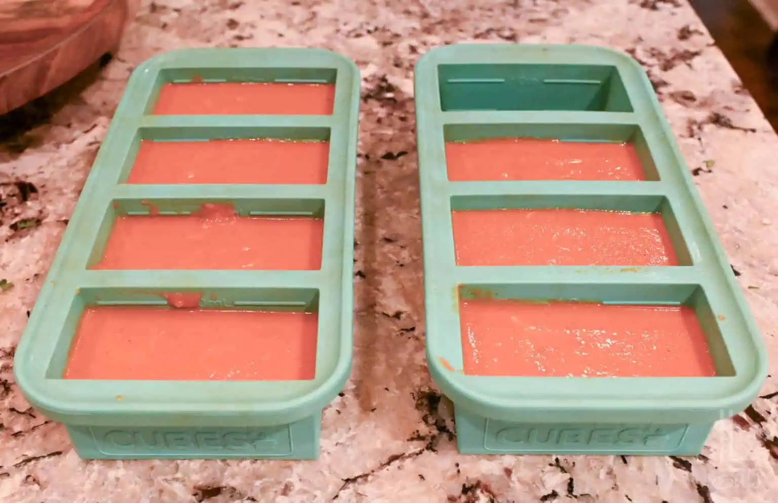 instant pot tomato soup in souper cubes freezing trays on a counter.