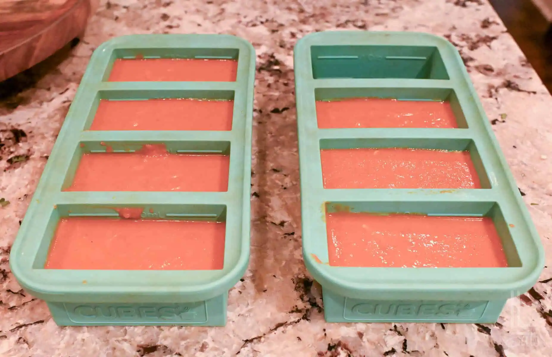 instant pot tomato soup in souper cubes freezing trays on a counter.