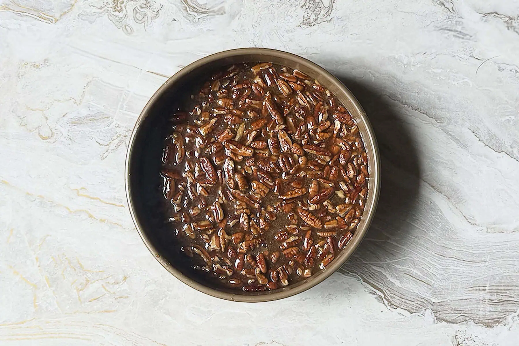 added pecans into the caramel mixture for the top of the pecan upside down cake.