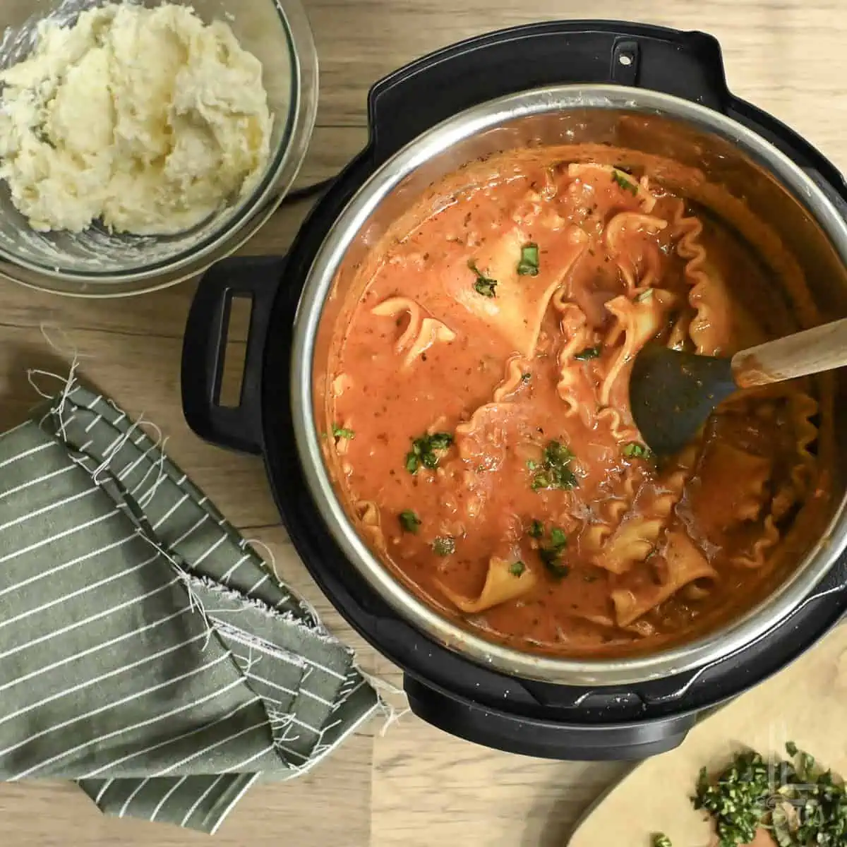 Lasagna soup topped with basil in an instant pot pressure cooker.