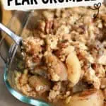 Close-up of canned pear crumble with oats in a glass baking dish.