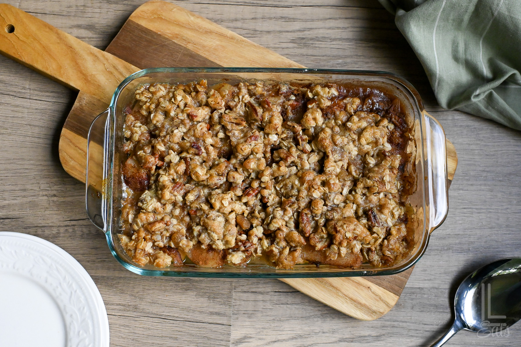 pear crumble after baking in a baking dish, on a cutting board.